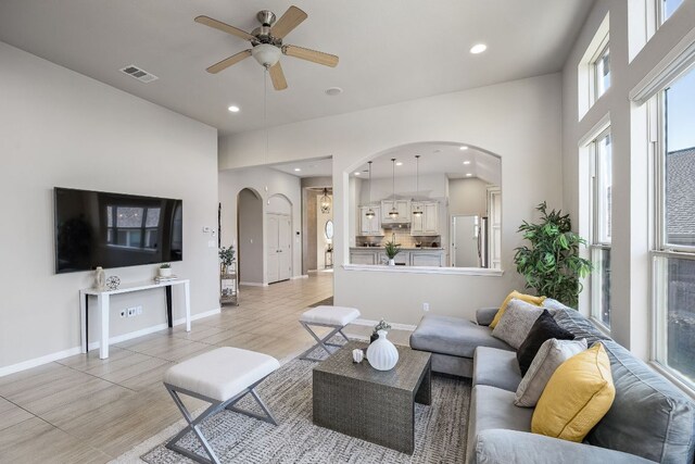 14320 Senia Bnd, Austin, TX 78738 - living area featuring arched walkways, a ceiling fan, plenty of natural light, recessed lighting, and baseboards