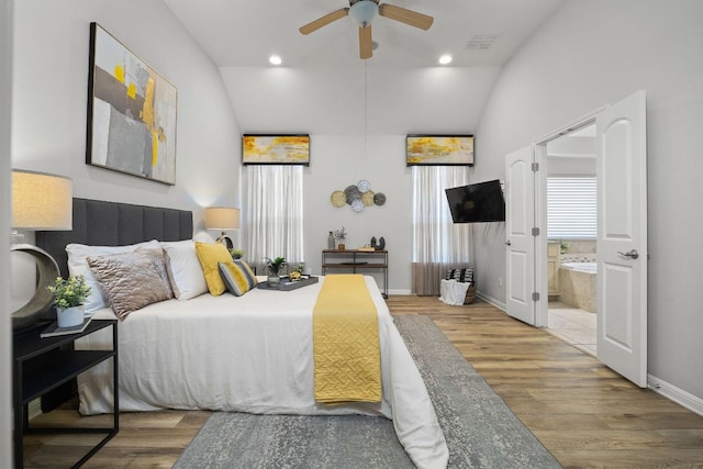 14320 Senia Bnd, Austin, TX 78738 - bedroom featuring visible vents, wood finished floors, ensuite bathroom, and vaulted ceiling