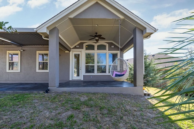 14320 Senia Bnd, Austin, TX 78738 - view of exterior entry featuring stucco siding, ceiling fan, and a patio area