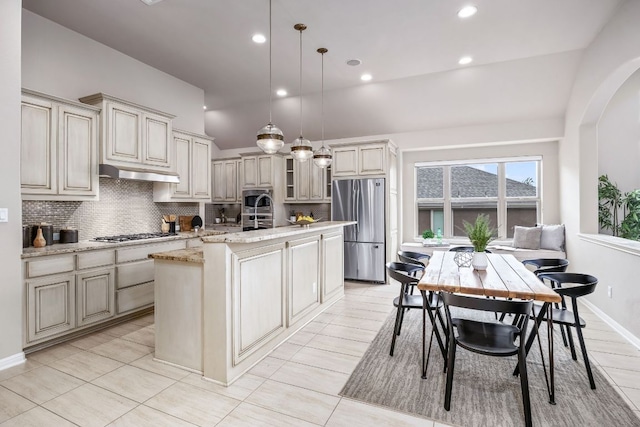 14320 Senia Bnd, Austin, TX 78738 - kitchen with pendant lighting, tasteful backsplash, stainless steel appliances, under cabinet range hood, and a center island with sink