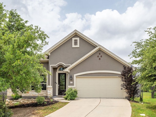 14320 Senia Bnd, Austin, TX 78738 - view of front of house with an attached garage, driveway, stucco siding, and fence