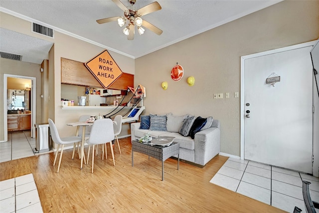 dining space with wood finished floors, a ceiling fan, and visible vents