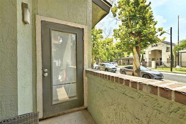 property entrance featuring stucco siding