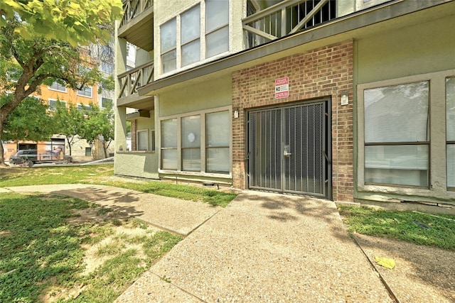 doorway to property with brick siding