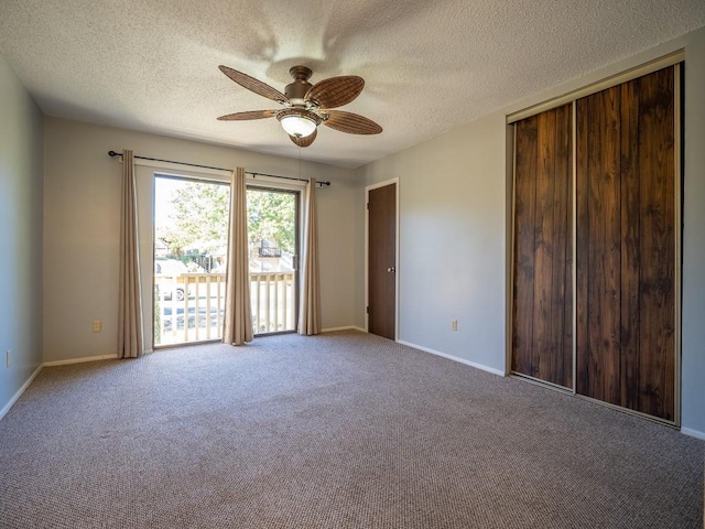 empty room with baseboards, carpet floors, a textured ceiling, and ceiling fan