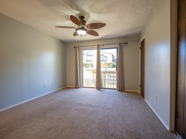 spare room with a ceiling fan, baseboards, carpet floors, and a textured ceiling