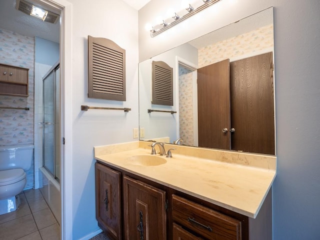 full bath with tile patterned floors, enclosed tub / shower combo, toilet, and vanity