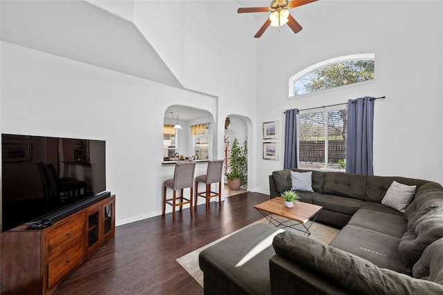 9209 Sweetgum Dr Unit 153, Austin, TX 78748 - living area featuring arched walkways, ceiling fan, wood finished floors, a high ceiling, and baseboards