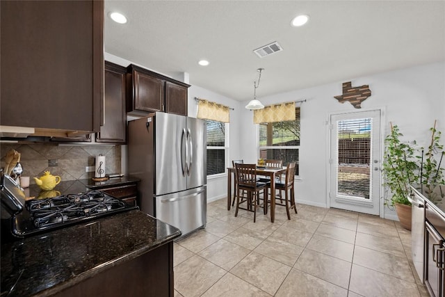 9209 Sweetgum Dr Unit 153, Austin, TX 78748 - kitchen featuring freestanding refrigerator, dark brown cabinetry, decorative backsplash, recessed lighting, and dark stone counters