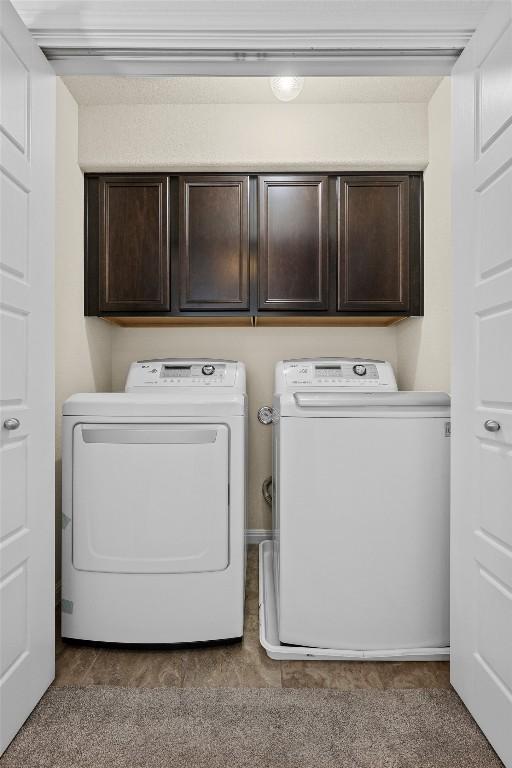 9209 Sweetgum Dr Unit 153, Austin, TX 78748 - laundry area featuring separate washer and dryer and cabinet space