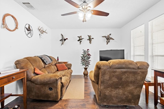 6705 Skynook Dr, Austin, TX 78745 - living area featuring a ceiling fan, dark wood-type flooring, and baseboards