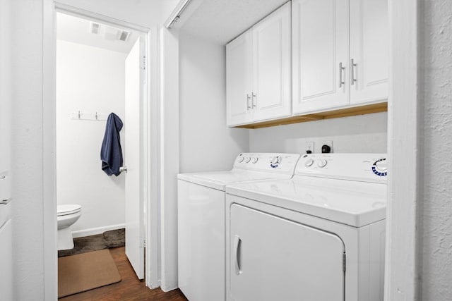 6705 Skynook Dr, Austin, TX 78745 - laundry room featuring cabinet space, washer and clothes dryer, dark wood finished floors, and baseboards