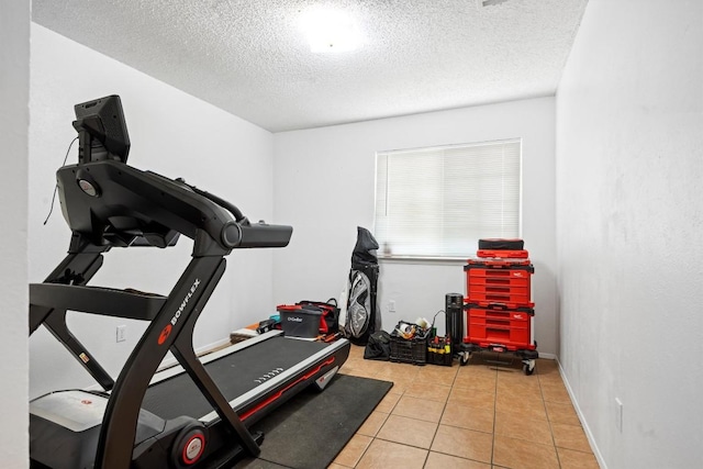6705 Skynook Dr, Austin, TX 78745 - workout area with a textured ceiling, tile patterned floors, and baseboards