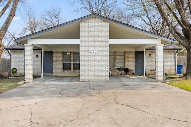 6705 Skynook Dr, Austin, TX 78745 - mid-century modern home featuring a carport, driveway, and brick siding