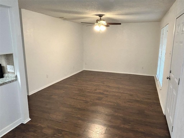 6705 Skynook Dr, Austin, TX 78745 - spare room with a ceiling fan, dark wood finished floors, and a textured ceiling