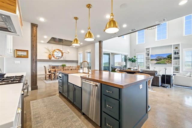 kitchen featuring visible vents, a sink, wood counters, finished concrete flooring, and stainless steel appliances