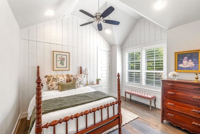 bedroom featuring vaulted ceiling, baseboards, a ceiling fan, and hardwood / wood-style flooring