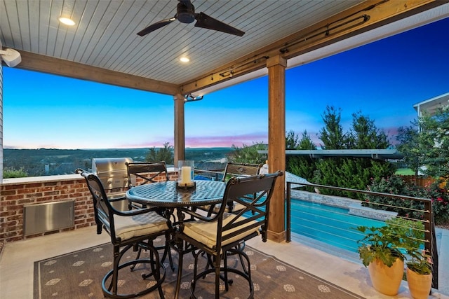 view of patio featuring outdoor dining area and a ceiling fan