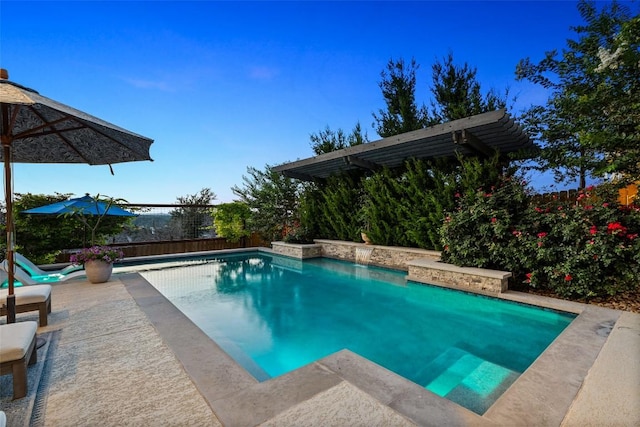 pool with a patio and a fenced backyard