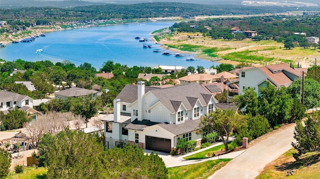 drone / aerial view with a residential view and a water view