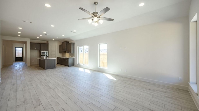 163 Plumbago Loop, Bastrop, TX 78602 - unfurnished living room with baseboards, recessed lighting, light wood finished floors, and a ceiling fan