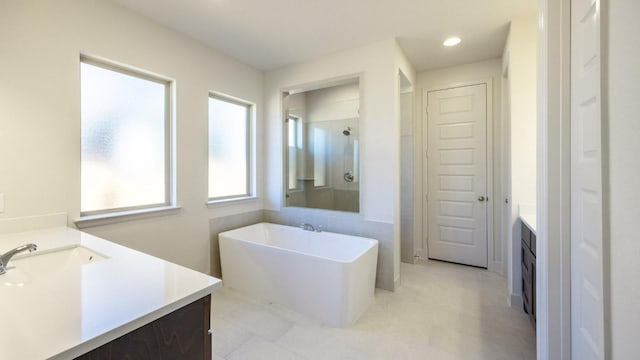 163 Plumbago Loop, Bastrop, TX 78602 - bathroom featuring vanity, a freestanding bath, walk in shower, a closet, and recessed lighting