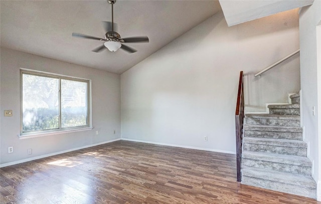 901 E Village Ln, Austin, TX 78758 - unfurnished living room featuring lofted ceiling, wood finished floors, a ceiling fan, stairs, and baseboards