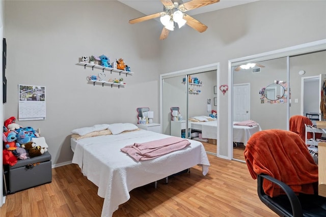807 W 25th St Unit 307, Austin, TX 78705 - bedroom with multiple closets, light wood finished floors, ceiling fan, and high vaulted ceiling