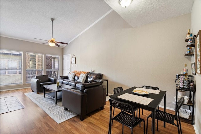 807 W 25th St Unit 307, Austin, TX 78705 - living room featuring a textured ceiling, a ceiling fan, lofted ceiling, and light wood-style floors