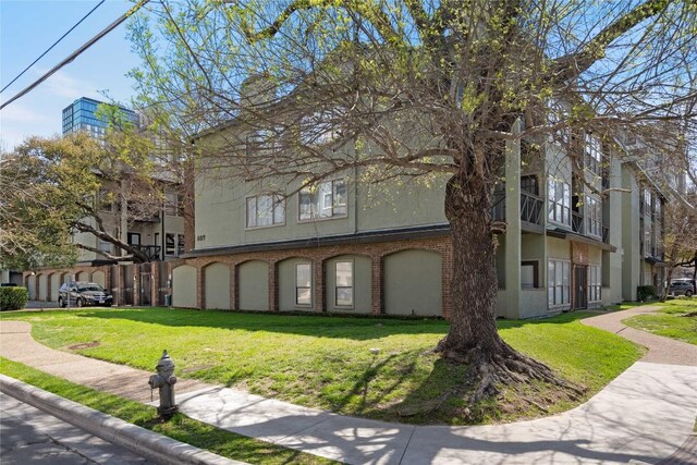 807 W 25th St Unit 307, Austin, TX 78705 - view of front of house with a front lawn, brick siding, and stucco siding