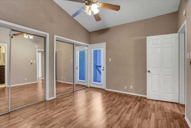 807 W 25th St Unit 307, Austin, TX 78705 - unfurnished bedroom with lofted ceiling, light wood-type flooring, two closets, and a ceiling fan