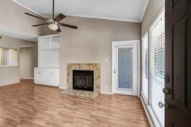807 W 25th St Unit 307, Austin, TX 78705 - unfurnished living room with healthy amount of natural light, light wood finished floors, crown molding, ceiling fan, and a textured ceiling