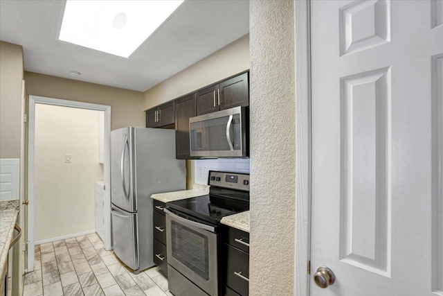 807 W 25th St Unit 307, Austin, TX 78705 - kitchen with appliances with stainless steel finishes and dark brown cabinetry