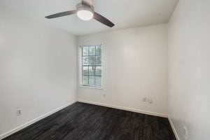 1102-1104-1106 Academy St, San Marcos, TX 78666 - spare room with dark wood-style floors and ceiling fan
