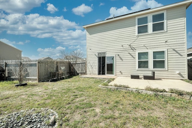 back of property with a patio, a lawn, and fence private yard