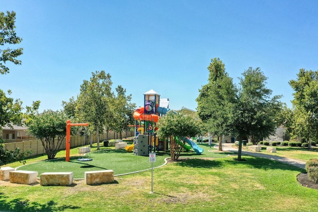 communal playground with a yard and fence