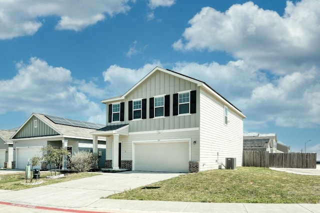 view of front facade featuring board and batten siding, a front lawn, fence, concrete driveway, and a garage