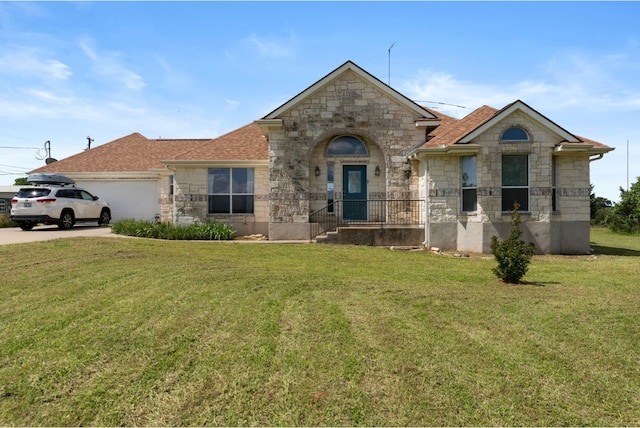 341 Brown Rd, Mcdade, TX 78650 - view of front of property featuring a shingled roof, a front lawn, a garage, stone siding, and driveway