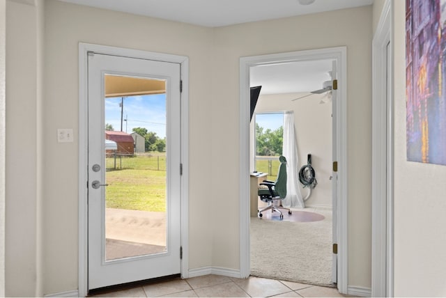 341 Brown Rd, Mcdade, TX 78650 - doorway to outside with light tile patterned flooring, light colored carpet, and baseboards