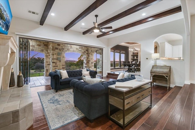 living room with visible vents, beam ceiling, wood finished floors, arched walkways, and ceiling fan