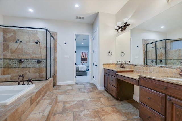 ensuite bathroom with visible vents, a garden tub, ensuite bath, a shower stall, and vanity