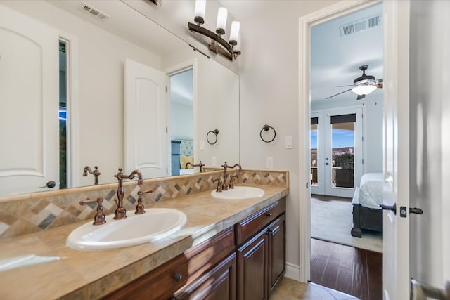 ensuite bathroom with double vanity, visible vents, and a sink