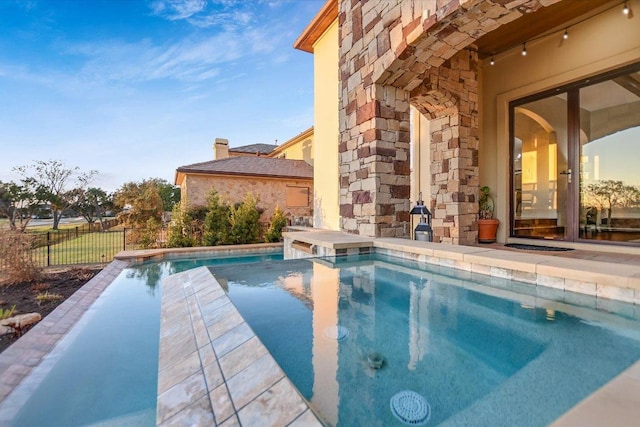 view of swimming pool featuring fence and a fenced in pool