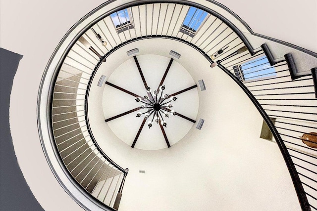 stairs featuring a notable chandelier and visible vents