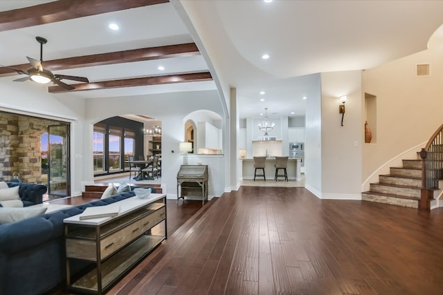 211 Jack Nicklaus Dr, Austin, TX 78738 - living room featuring ceiling fan, arched walkways, stairway, wood-type flooring, and beamed ceiling