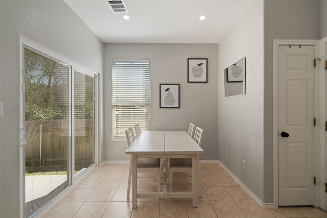 dining room with light tile patterned floors, recessed lighting, and baseboards