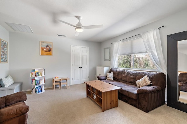 living area featuring visible vents, light carpet, baseboards, and ceiling fan