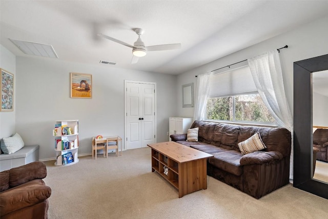 living room featuring light colored carpet, ceiling fan, and baseboards