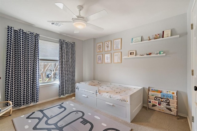 carpeted bedroom featuring a ceiling fan and baseboards