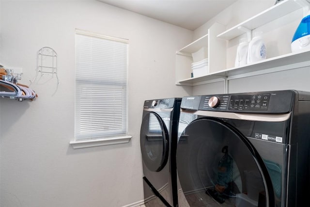 clothes washing area with washing machine and dryer and laundry area